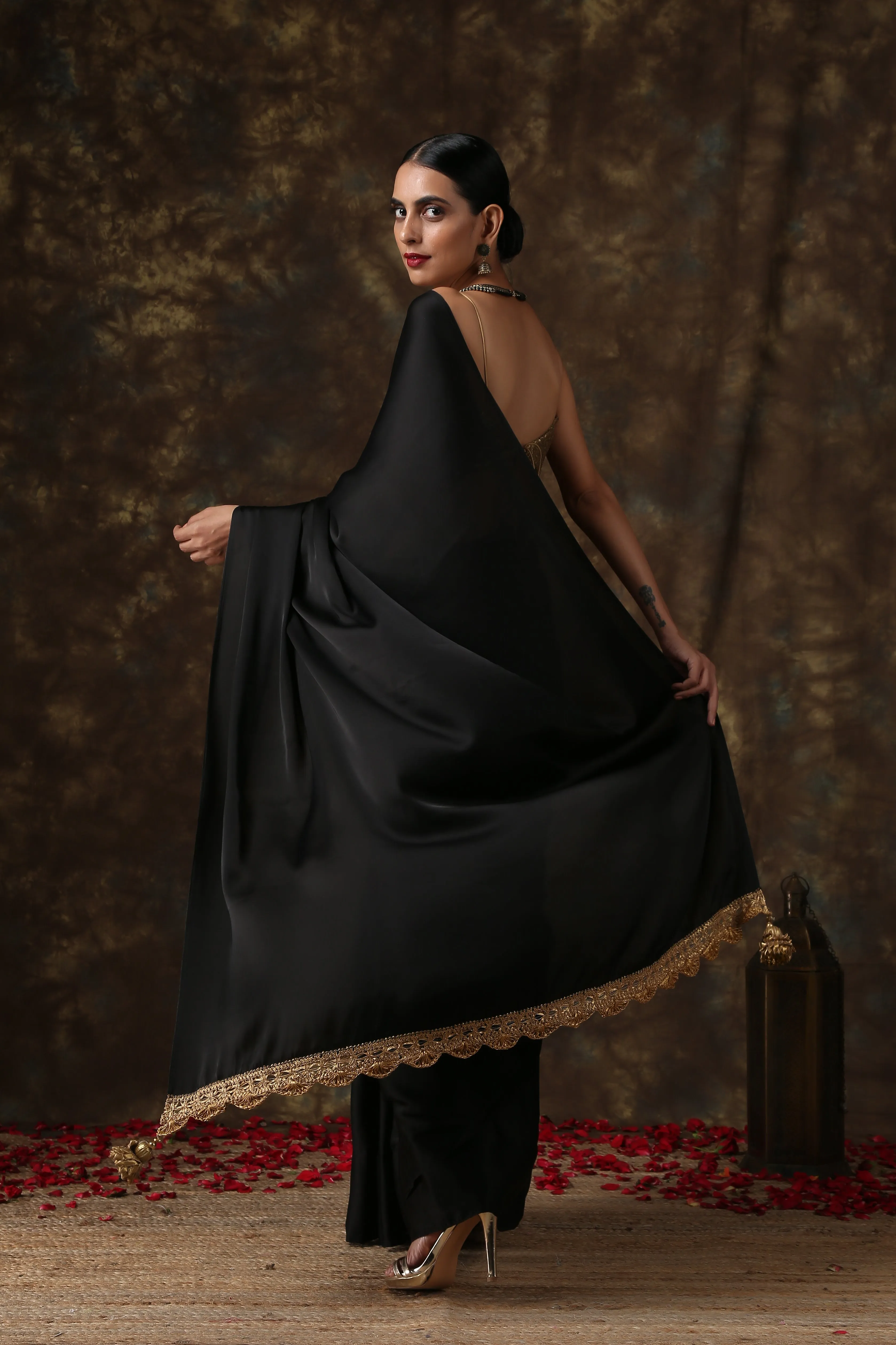 Luxurious Black Satin Saree with Dull Gold Lace and Pendants